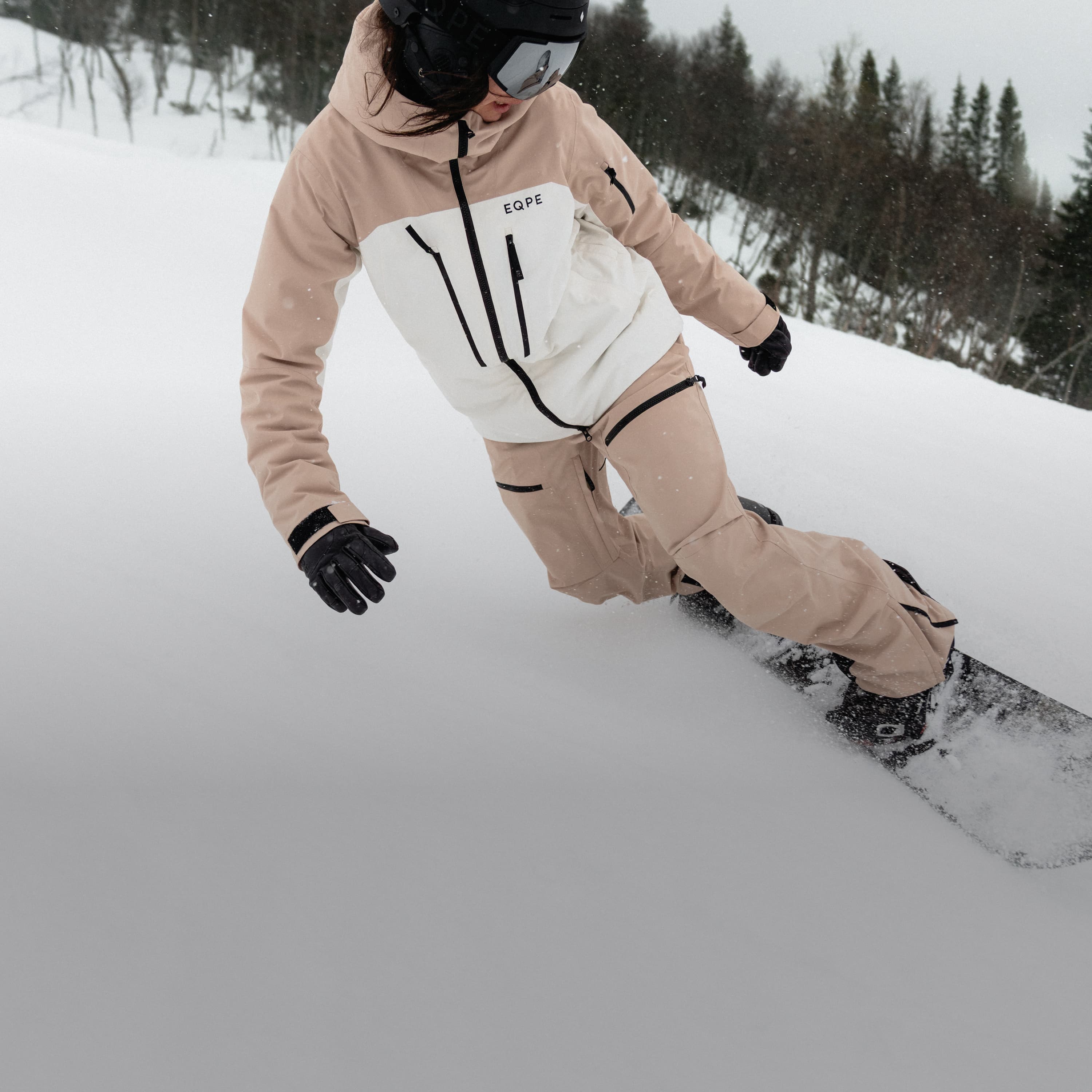Snowboarder carving through fresh snow.